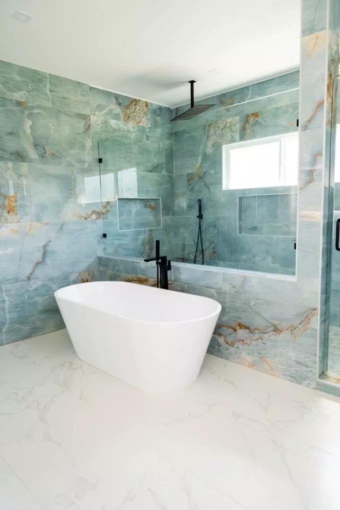 Stunning master bathroom with aqua blue 24x48 large format tiles, freestanding tub, and shower that is sure to impress Stunning master bathroom with aqua blue 24x48 large format tiles, freestanding tub, and shower that is sure to impress