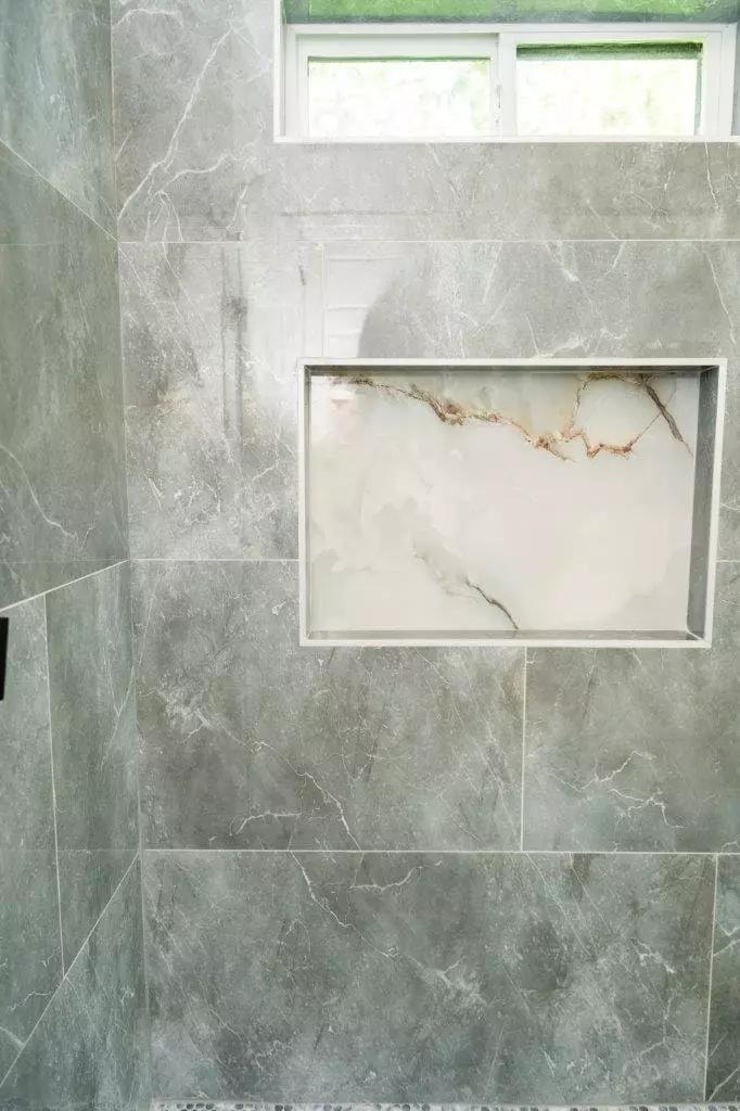 Beautiful shower with large format polish stone gray tiles and contrasted tile shower niche that will make your home the envy of your friends Beautiful shower with large format polish stone gray tiles and contrasted tile shower niche that will make your home the envy of your friends