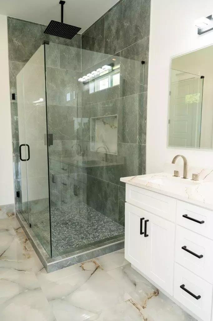 Stunning bathroom with large format polish stone gray tiles that are easy to clean and perfect for a modern look Stunning bathroom with large format polish stone gray tiles that are easy to clean and perfect for a modern look