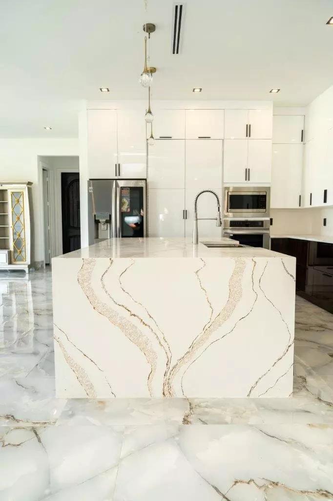 Stunning kitchen with wave pattern quartz countertops and waterfall design that add a touch of luxury Stunning kitchen with wave pattern quartz countertops and waterfall design that add a touch of luxury