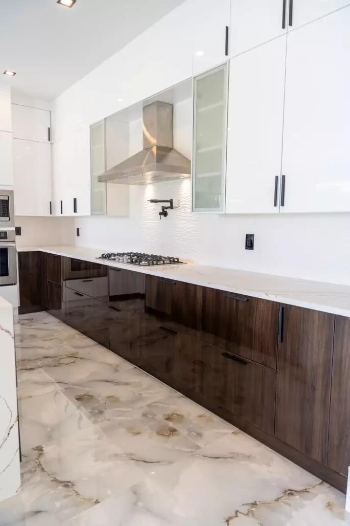 Stunning kitchen with wave pattern quartz countertops, European style frameless cabinets, and contrasting colors that create a modern and stylish space Stunning kitchen with wave pattern quartz countertops, European style frameless cabinets, and contrasting colors that create a modern and stylish space
