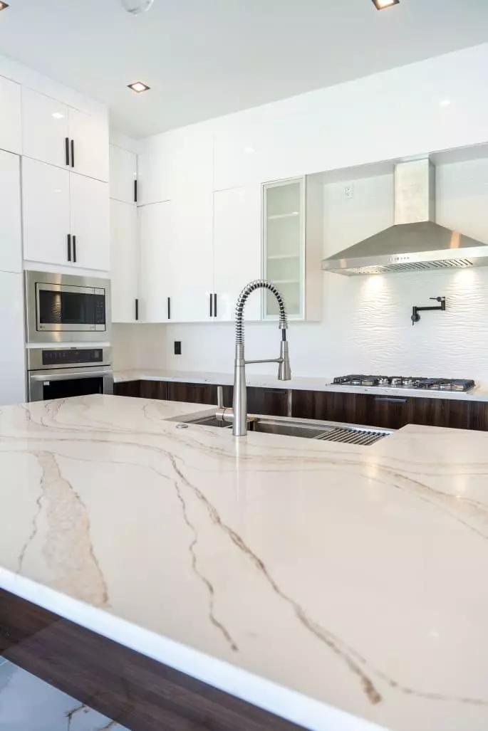 Beautiful kitchen with wave pattern quartz countertops, European style frameless cabinets, and hand made under mount kitchen sink that is sure to impress Beautiful kitchen with wave pattern quartz countertops, European style frameless cabinets, and hand made under mount kitchen sink that is sure to impress