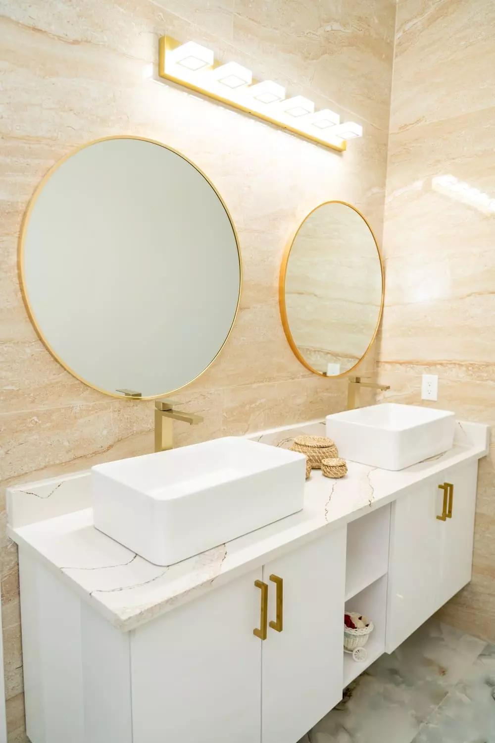 Luxurious bathroom with quartz countertops, top mount porcelain sinks, and polished wall tile Luxurious bathroom with quartz countertops, top mount porcelain sinks, and polished wall tile