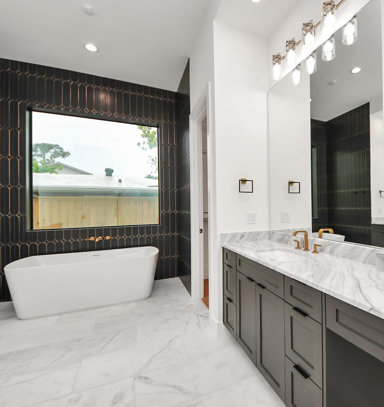 Beautiful bathroom with marble-look tile, statement accent walls, and contrast cabinetry in Houston, TX. Beautiful bathroom with marble-look tile, statement accent walls, and contrast cabinetry in Houston, TX.